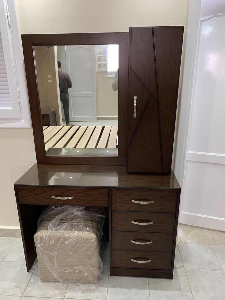 five drawer tabele attached with a mirror on top and a closed side section for bedroom